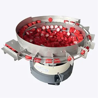 Industrial vibratory bowl feeder separating red plastic components for counting